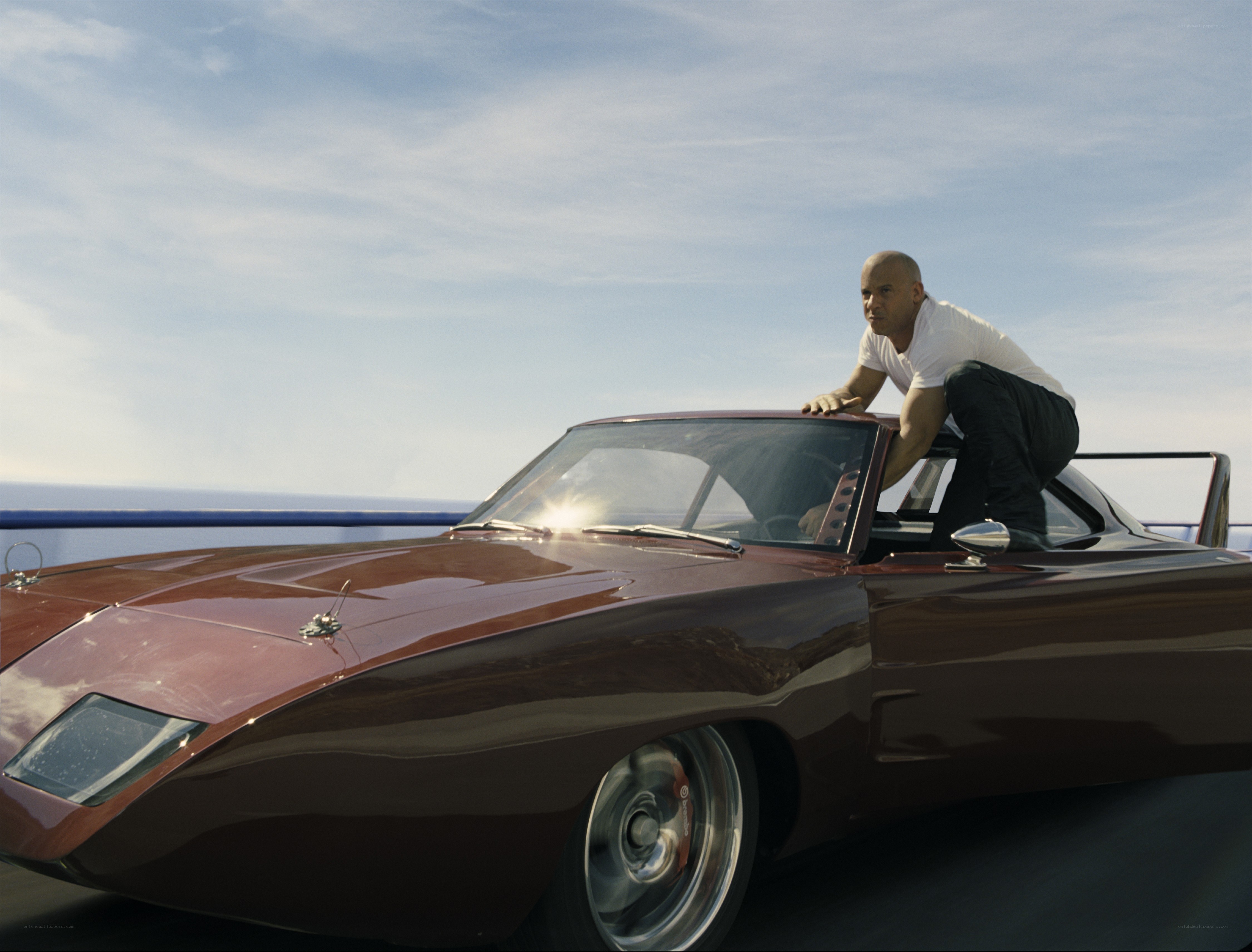 man on classic car roof