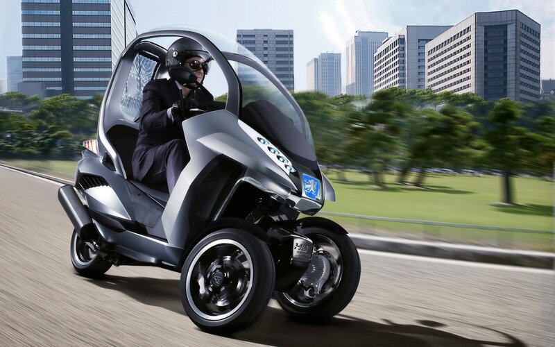 Man on futuristic three-wheeled vehicle