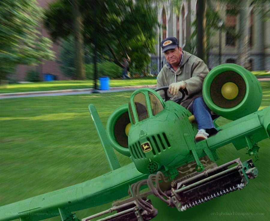 man on green lawn mower