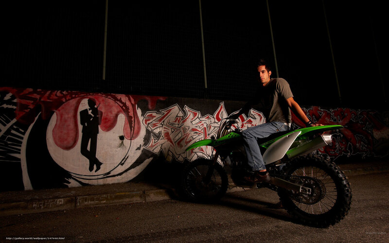 man on green motorcycle at night
