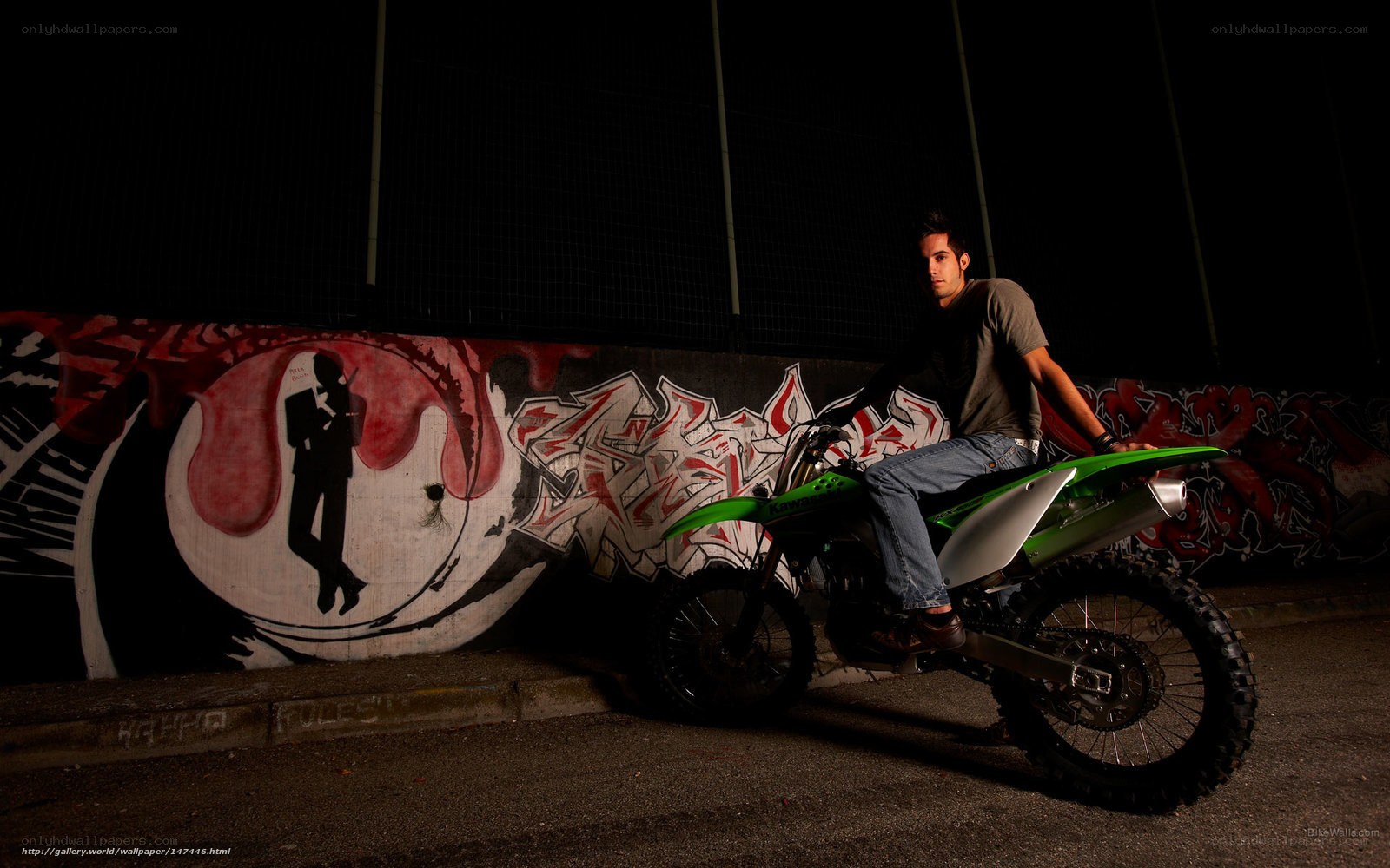 man on green motorcycle at night