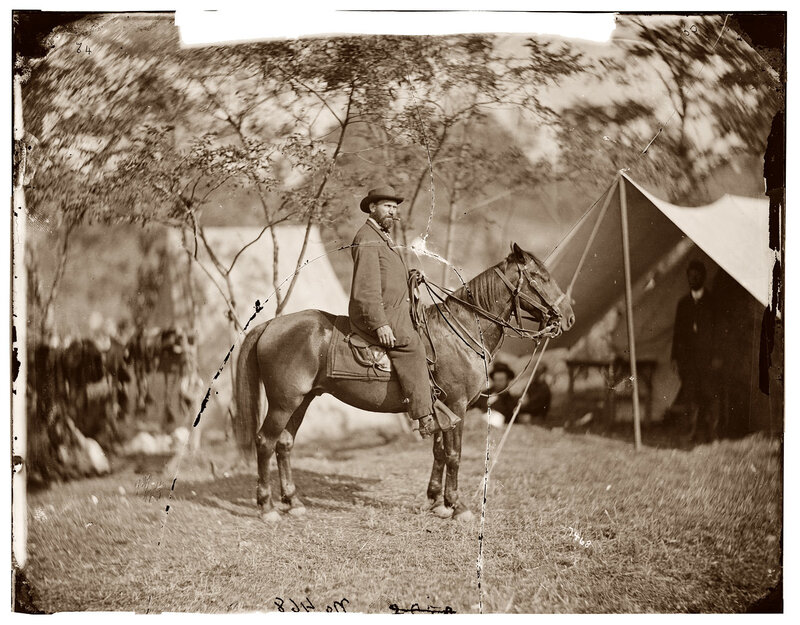 Man on horseback in camp
