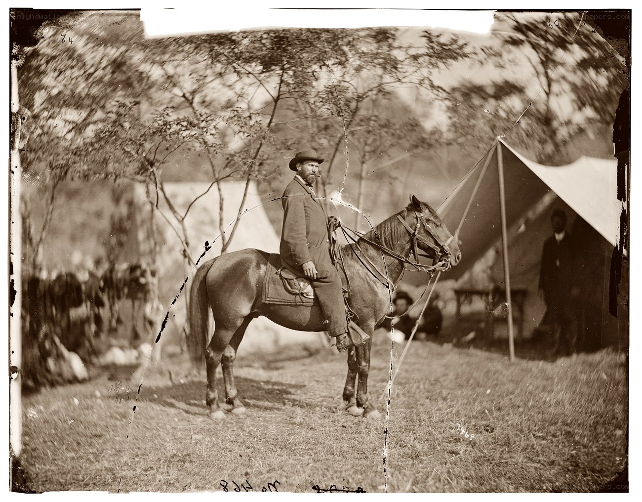Man on horseback in camp