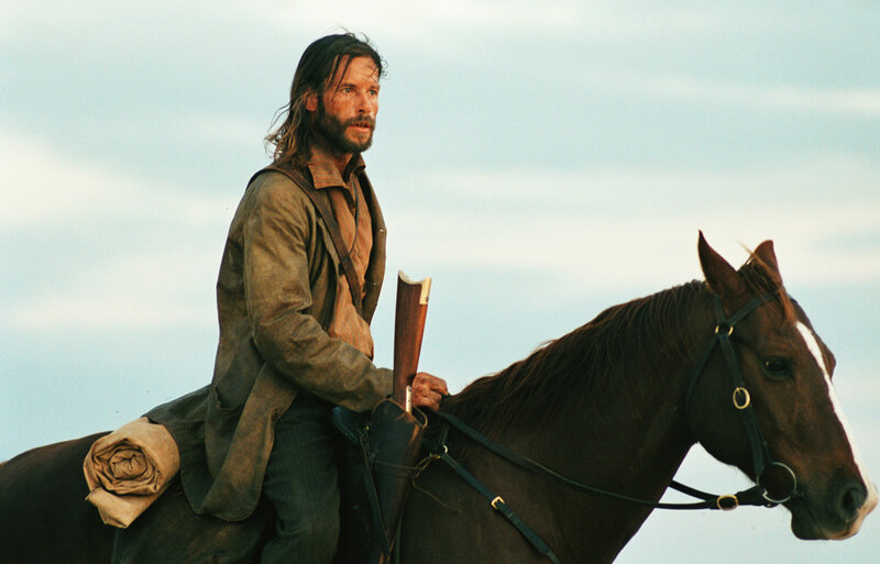 Man on horseback with rifle