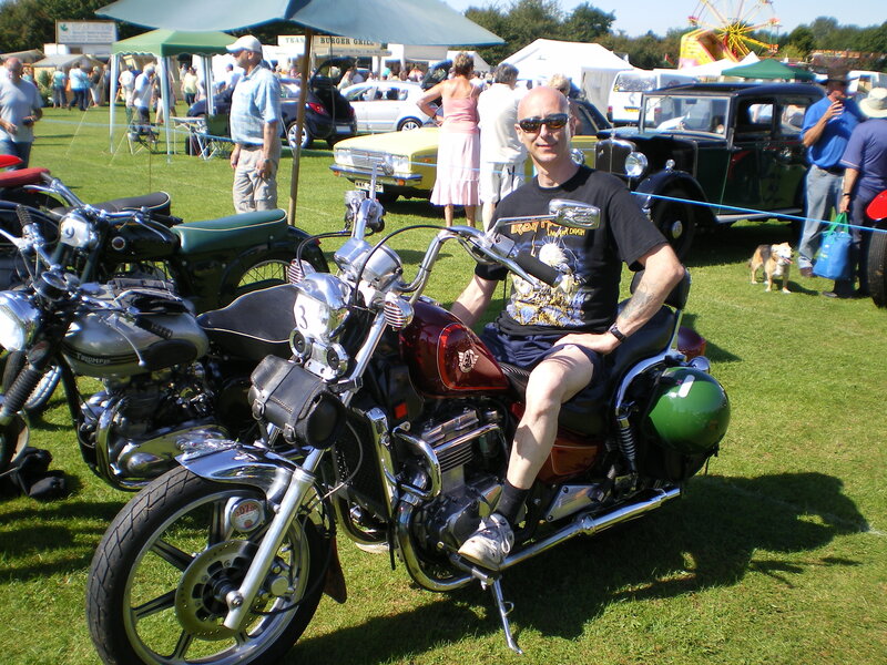 Man on motorcycle at car show