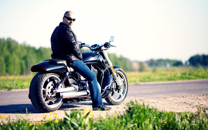 man on motorcycle by road