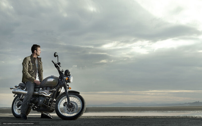 Man on motorcycle by the sea