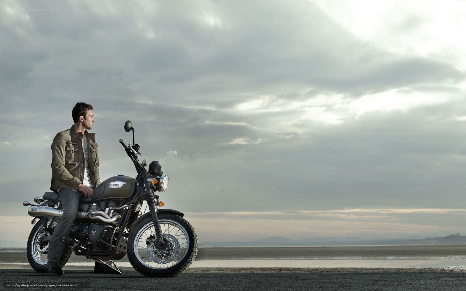 Man on motorcycle by the sea