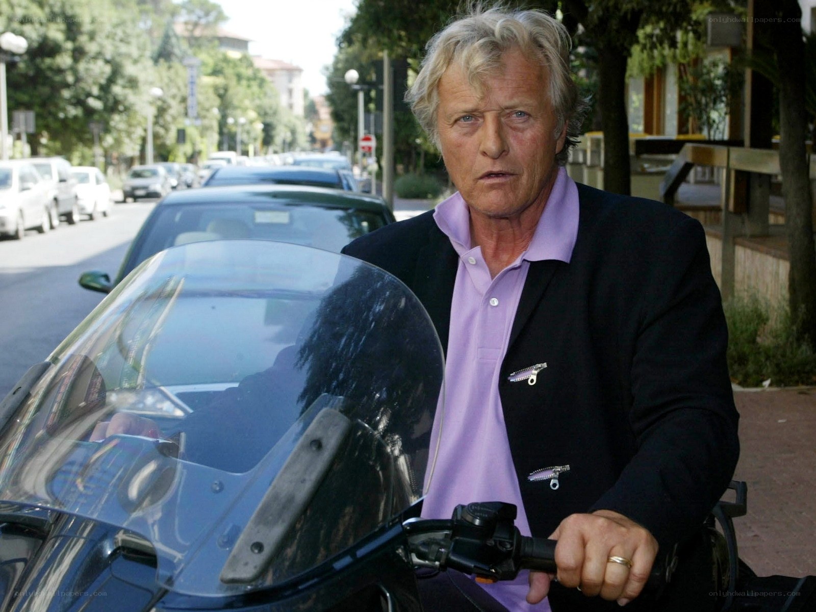 man on motorcycle in city