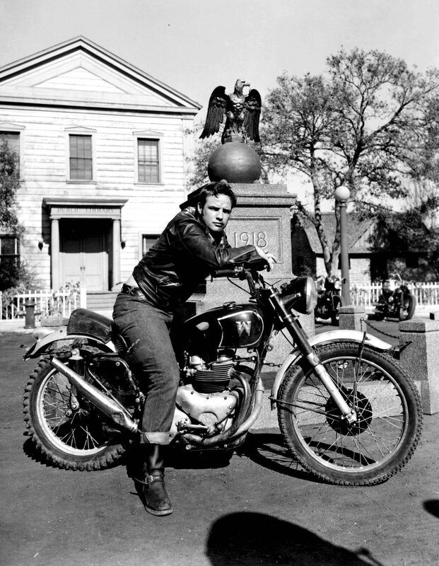 Man on motorcycle in front of library