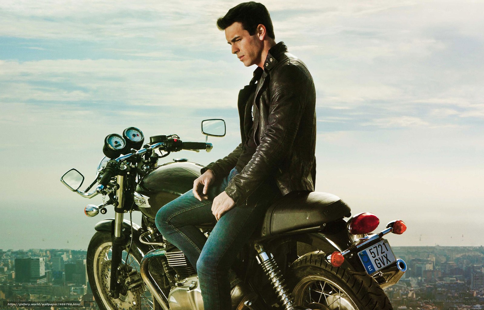 man on motorcycle overlooking city
