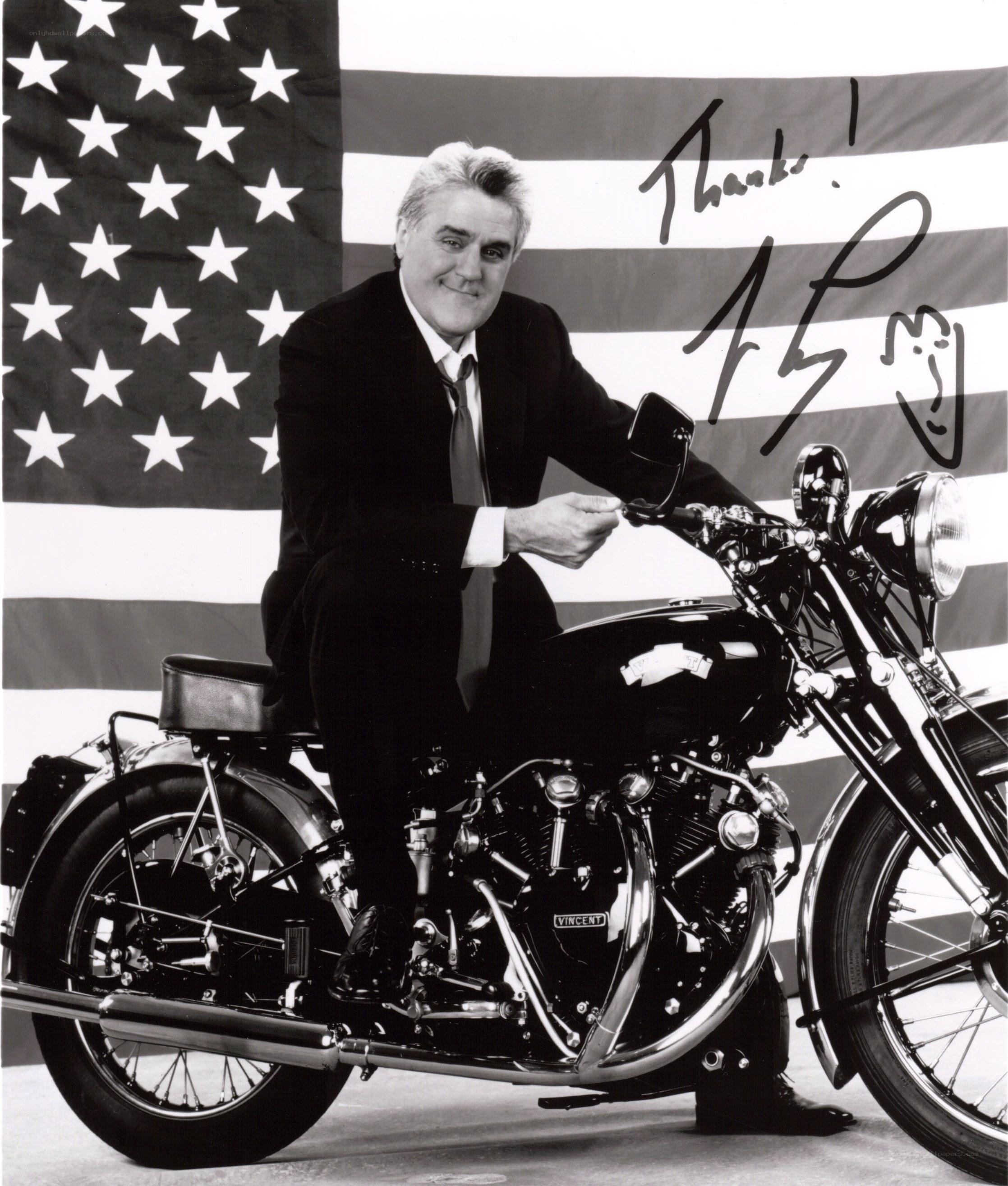 Man on motorcycle with flag