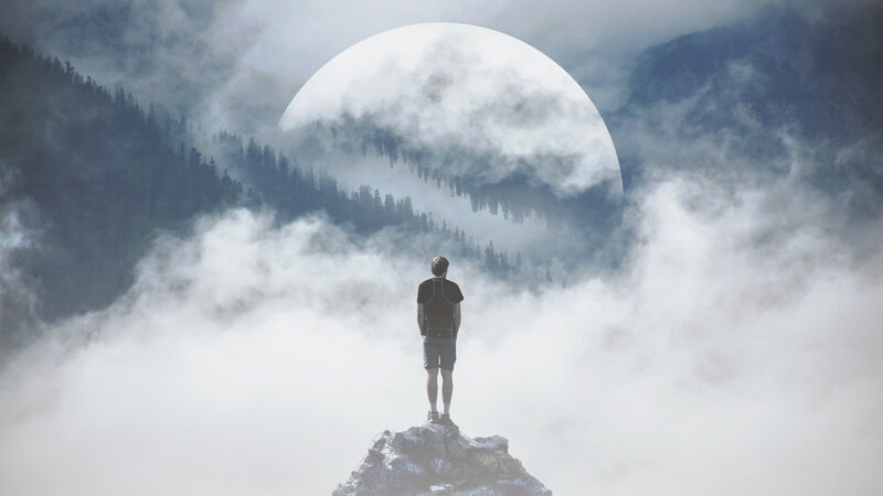 Man on Mountain Peak — Gray