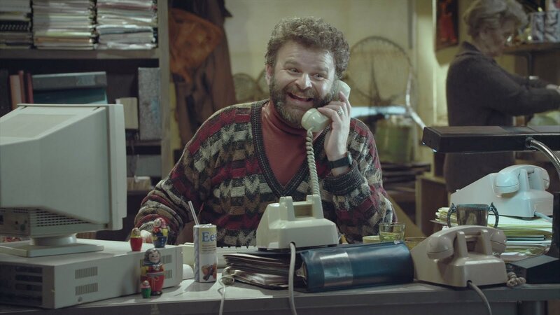 Man on phone at office desk