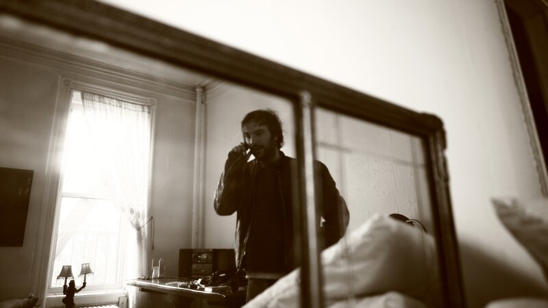 man on phone in bedroom