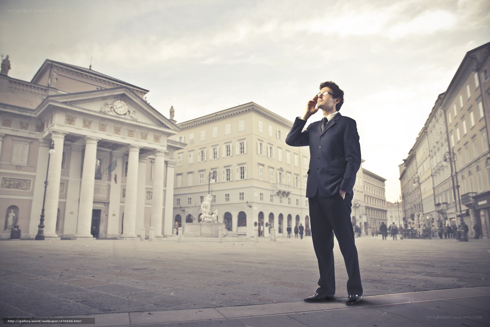 Man on phone in city square