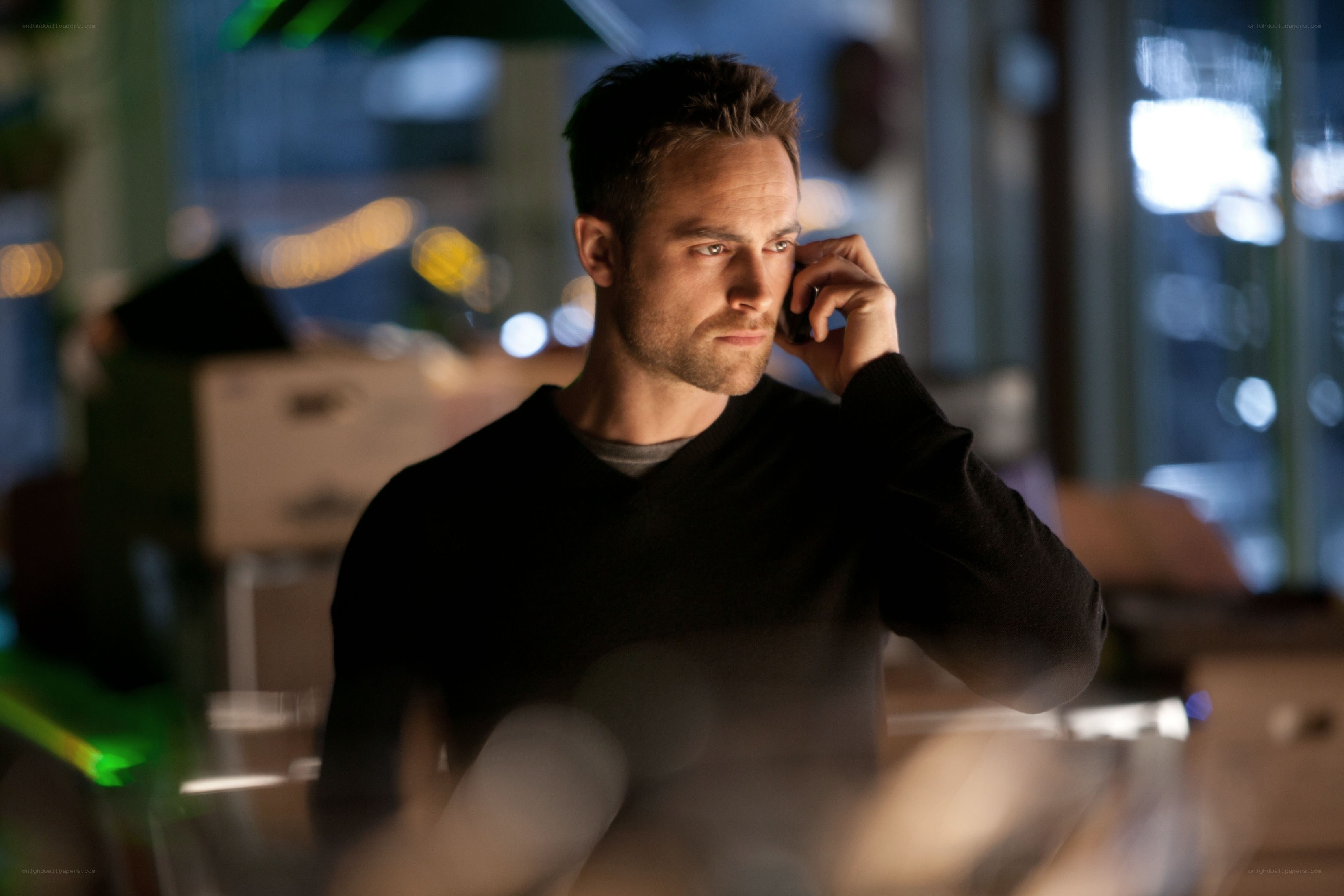 man on phone in dim room