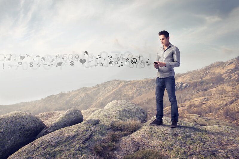Man on phone in mountain landscape