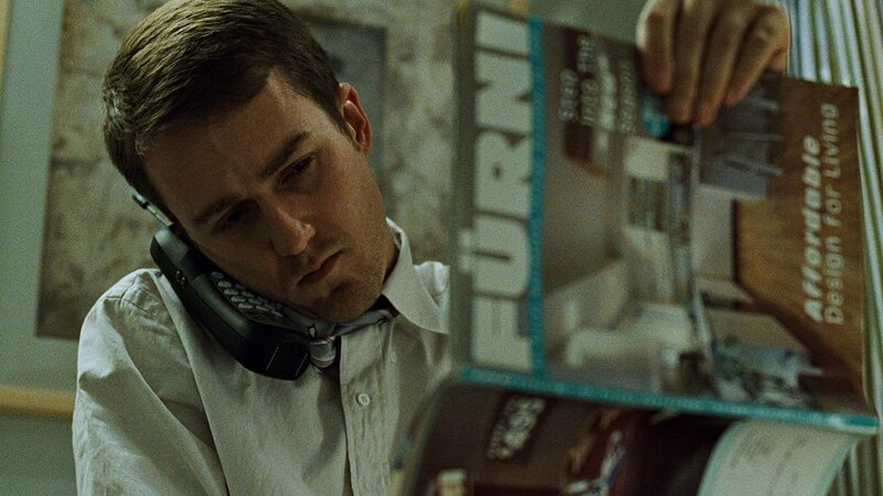 man on phone reading magazine