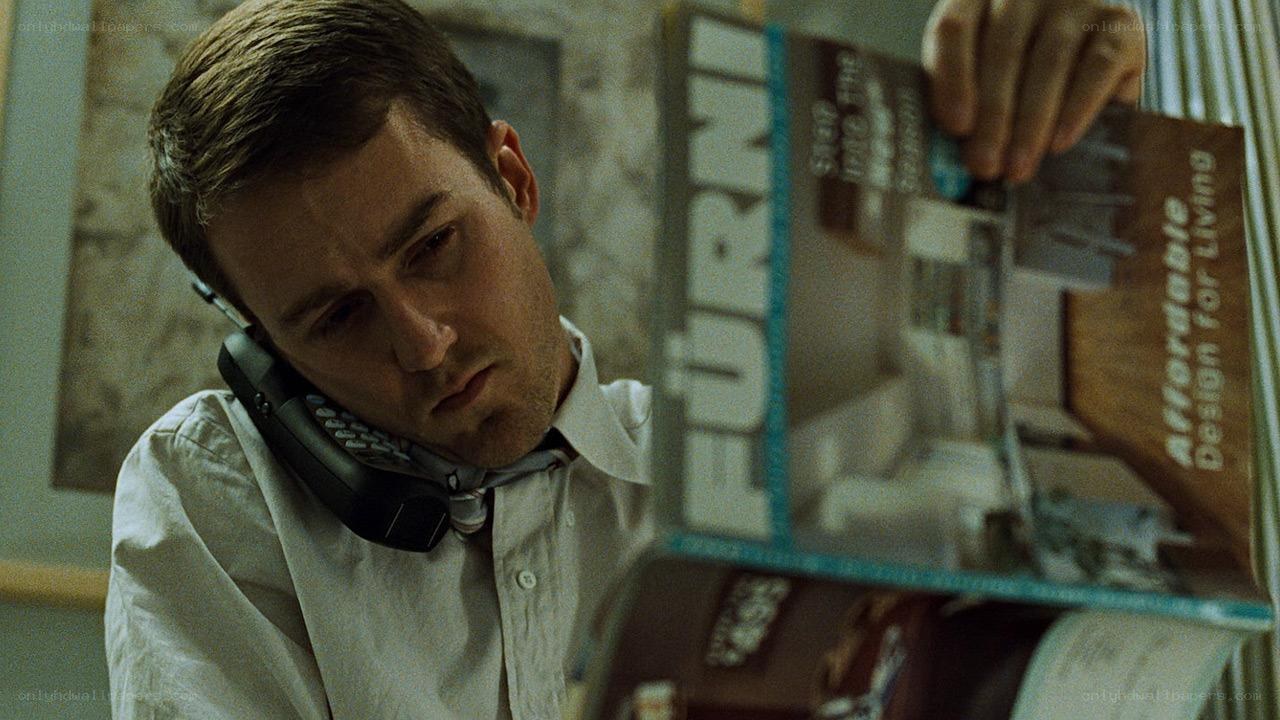 man on phone reading magazine