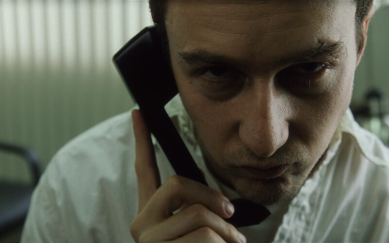 man on phone with bruised eye