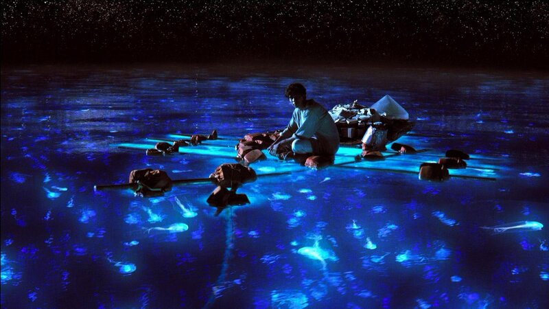 Man on raft in glowing water
