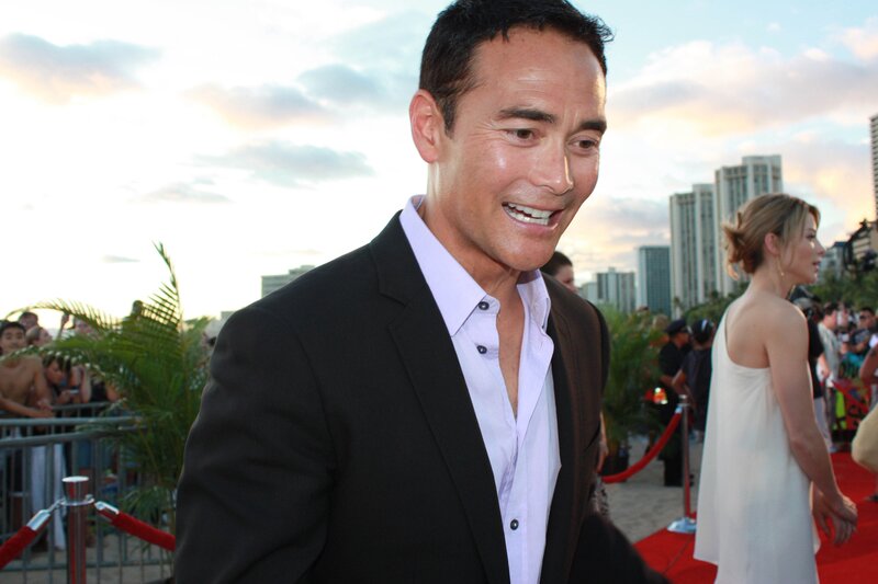 man on red carpet smiling