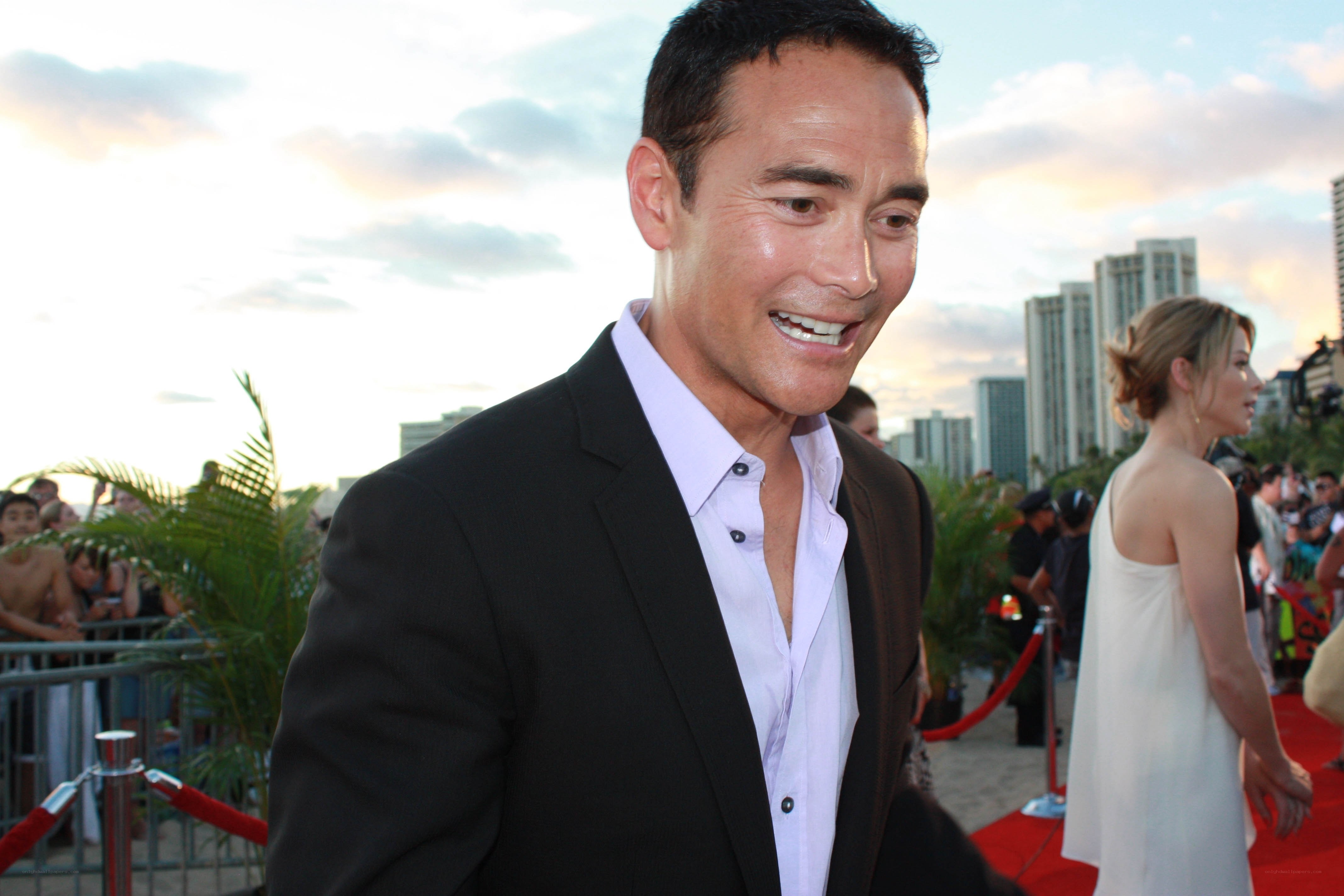 man on red carpet smiling