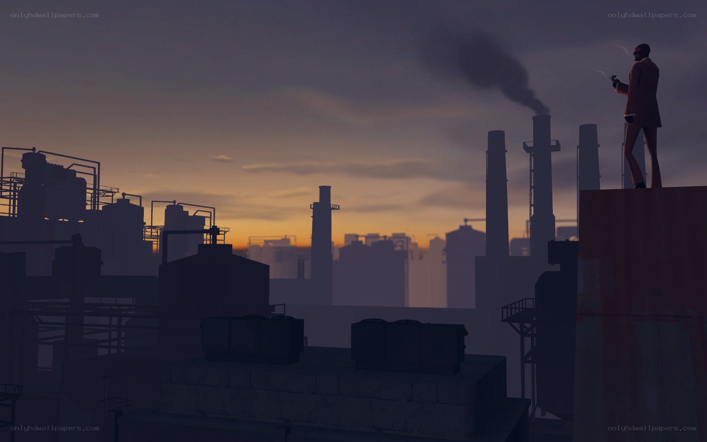 Man on rooftop at industrial sunset