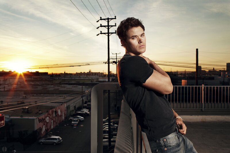 man on rooftop at sunset