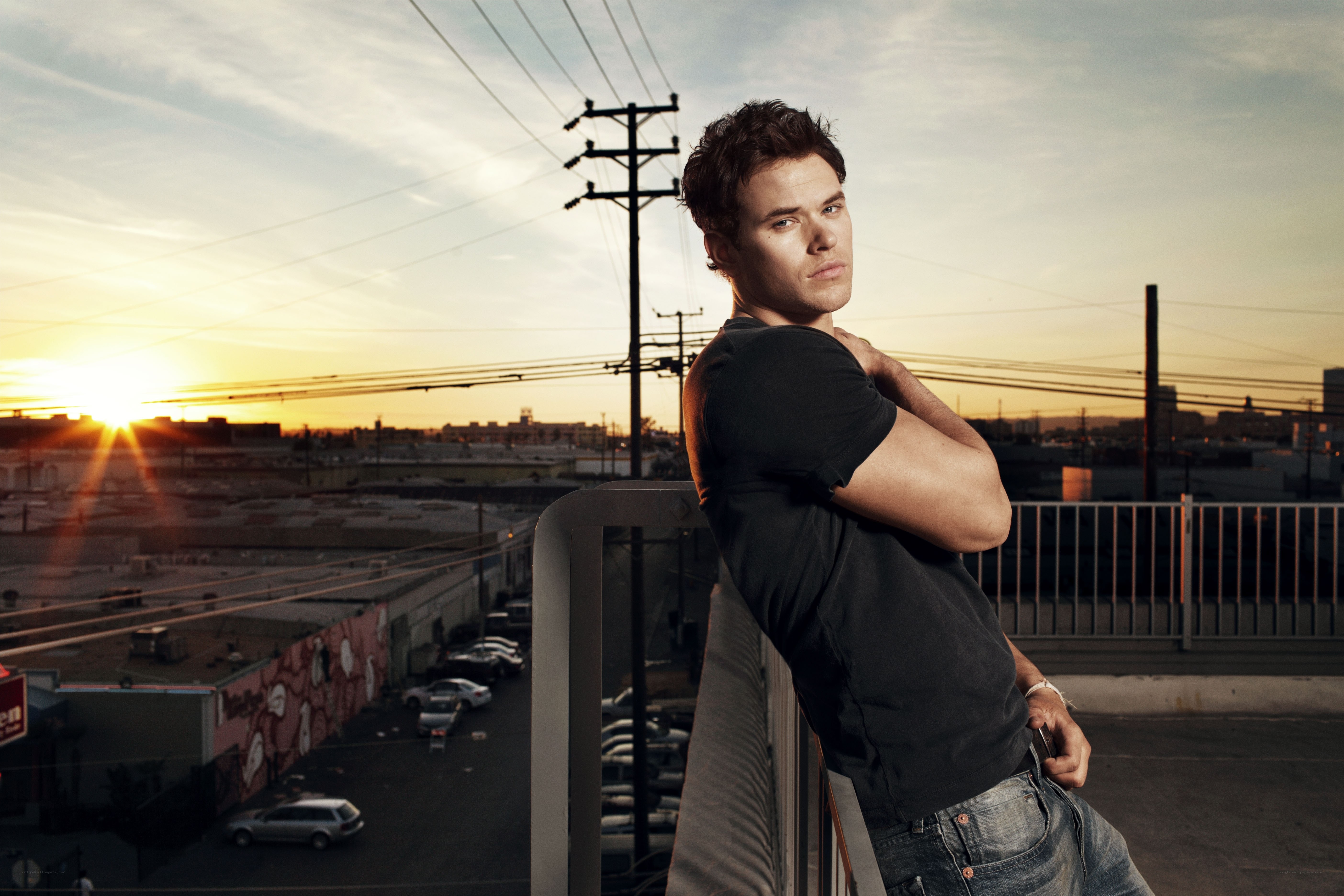 man on rooftop at sunset