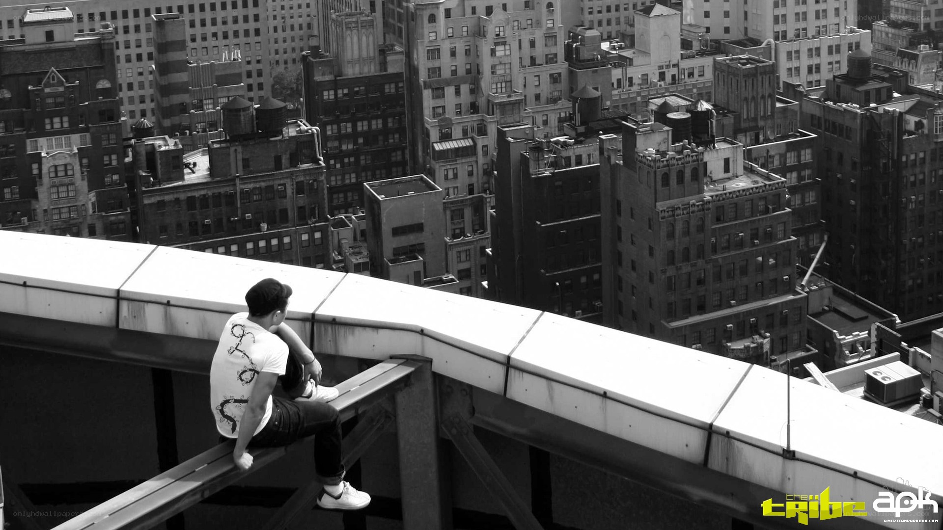Man on rooftop overlooking city