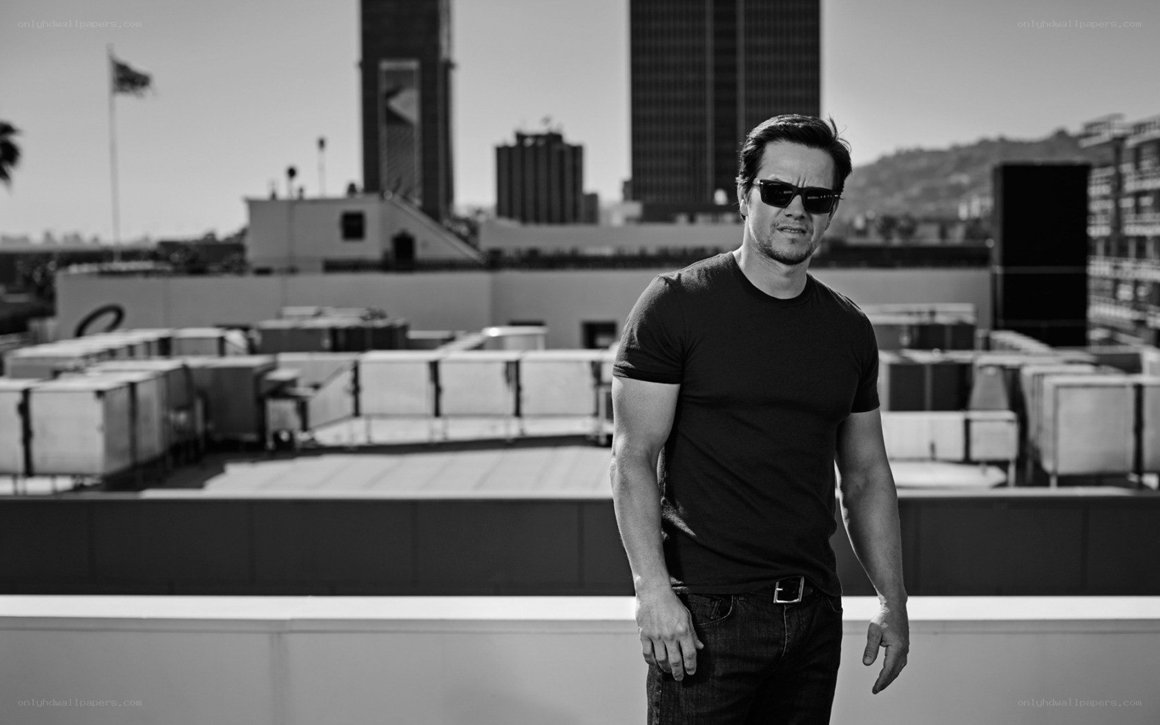 Man on rooftop with city view