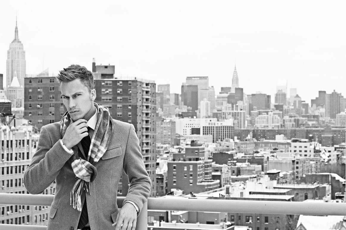 man on rooftop with city view