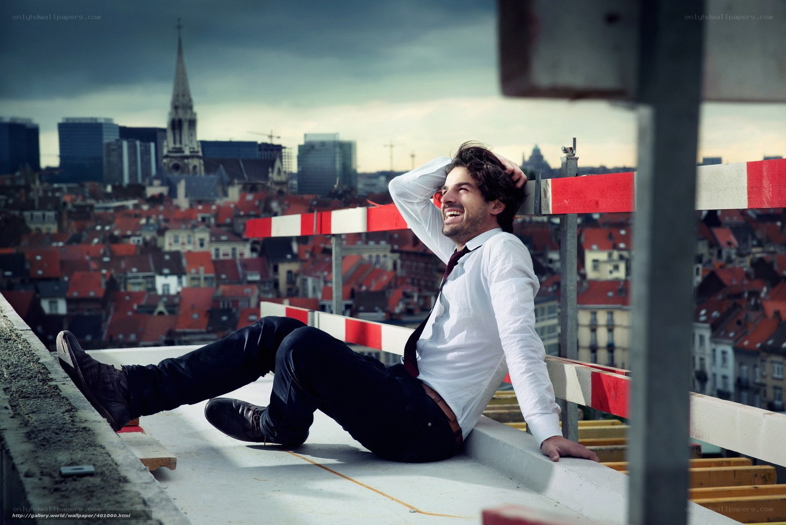 Man on rooftop with city view