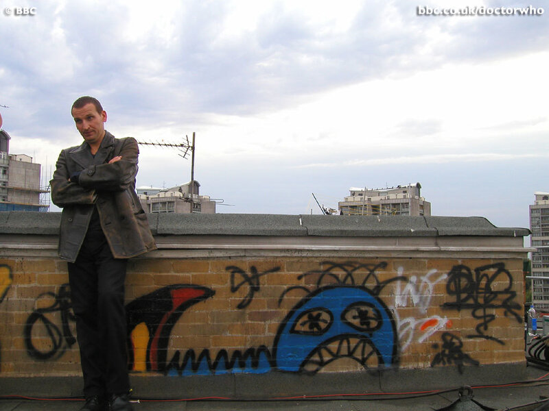 man on rooftop with graffiti