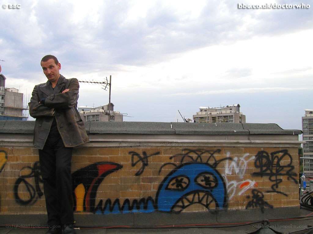 man on rooftop with graffiti