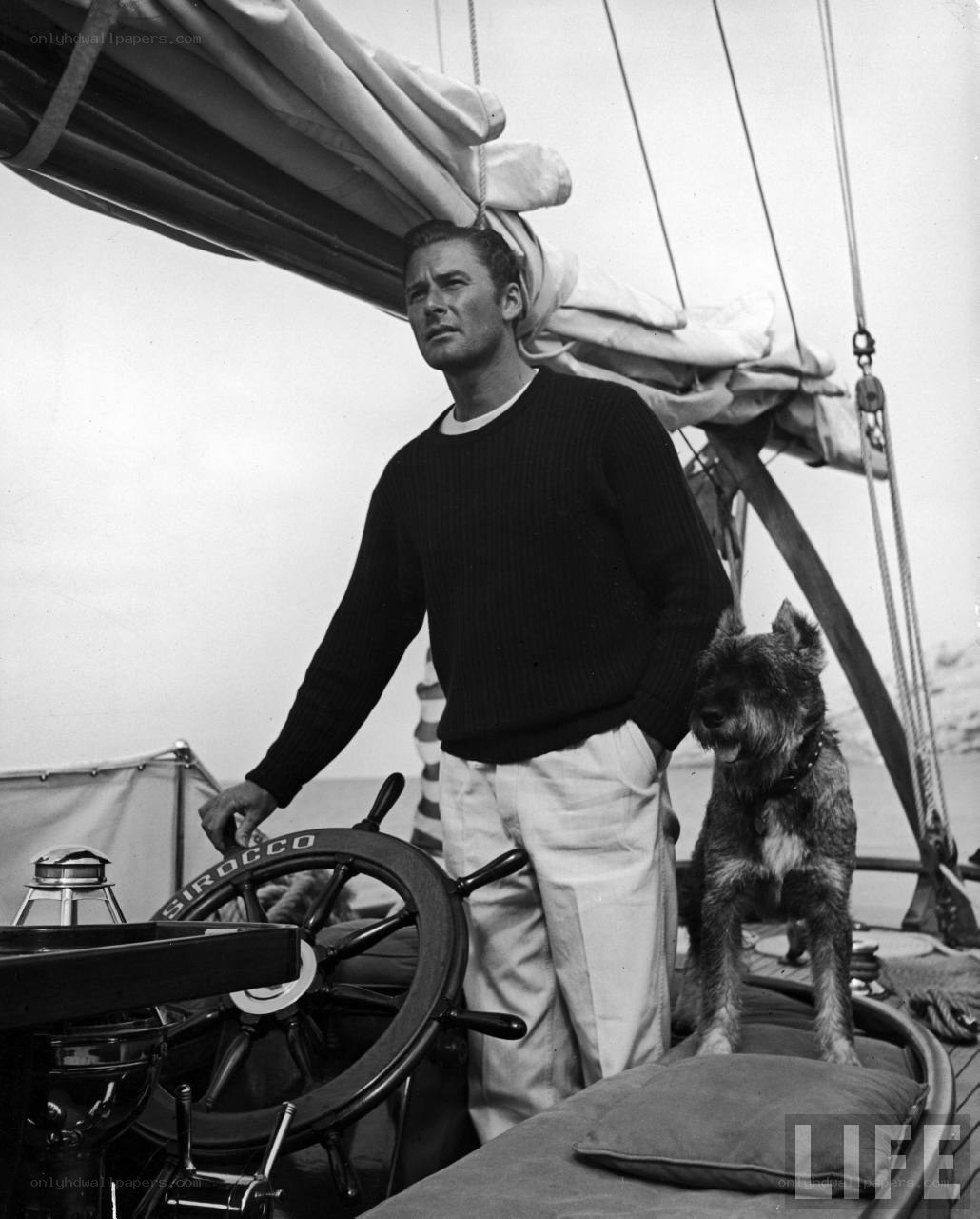 man on sailboat with dog