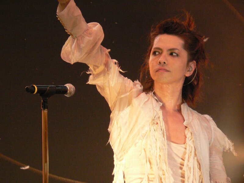 Man on Stage Performing — White, Dramatic