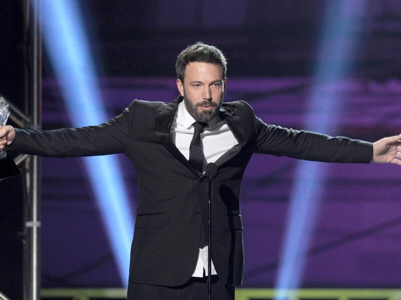Man on Stage with Award