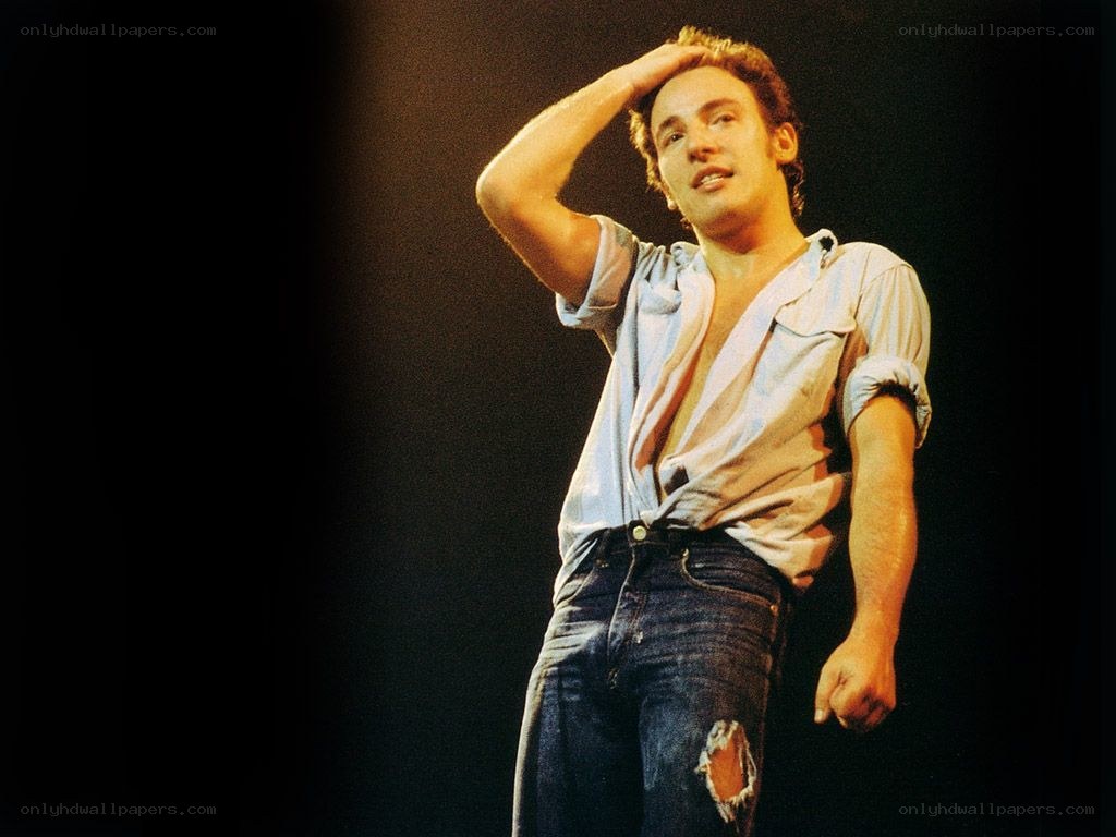 man on stage with hand on head