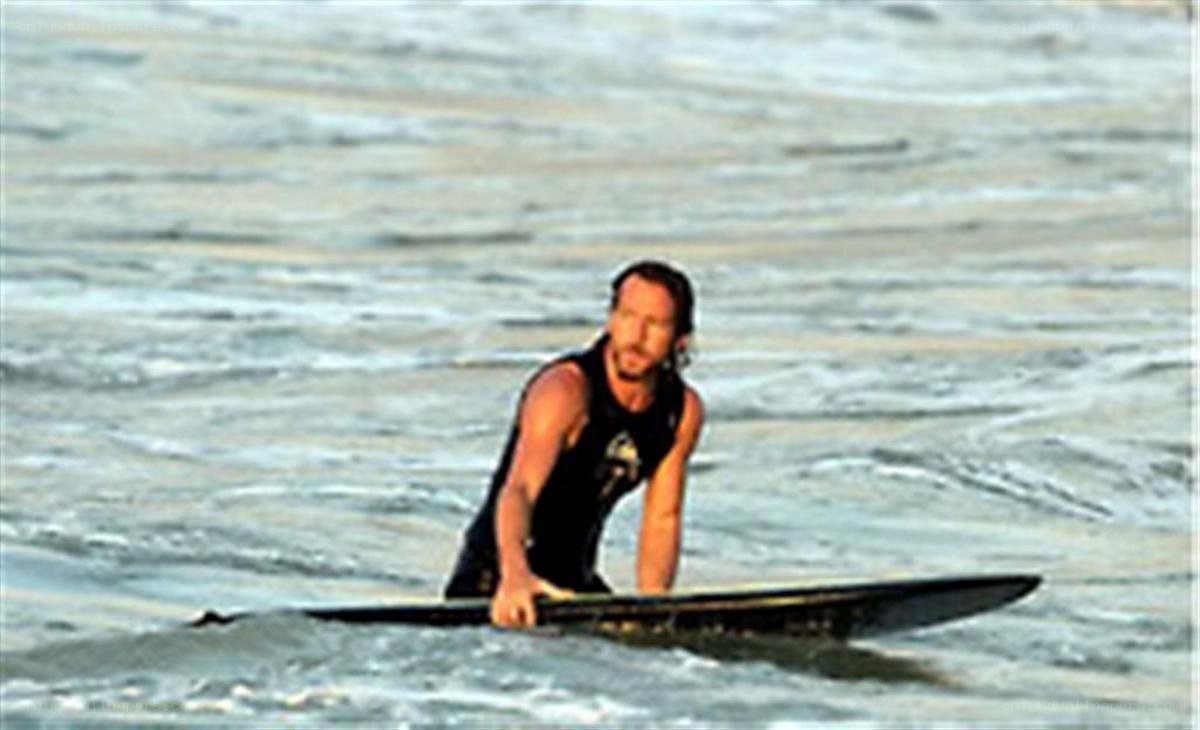 man on surfboard in ocean