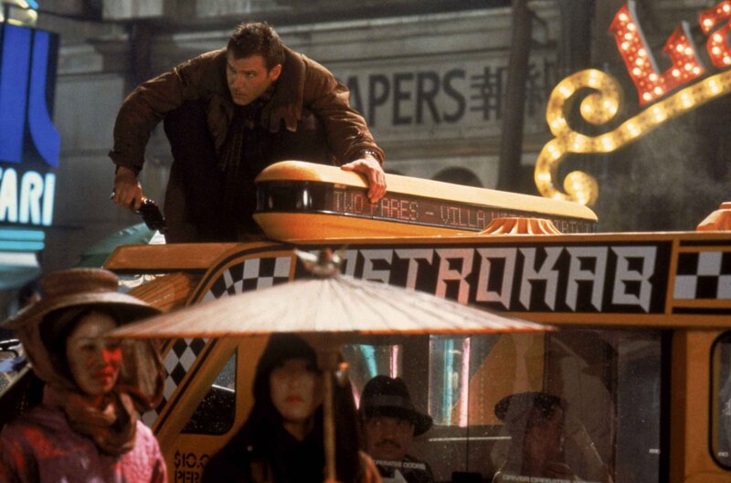 Man on taxi roof at night