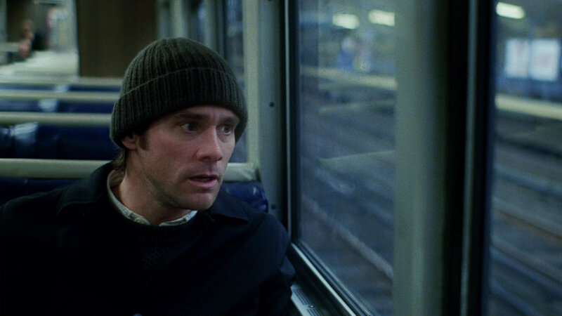 man on train looking out window