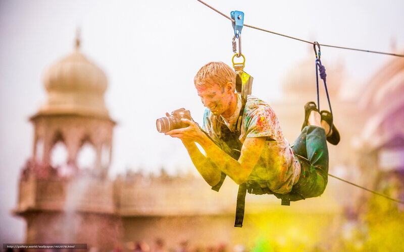 Man on zipline with camera