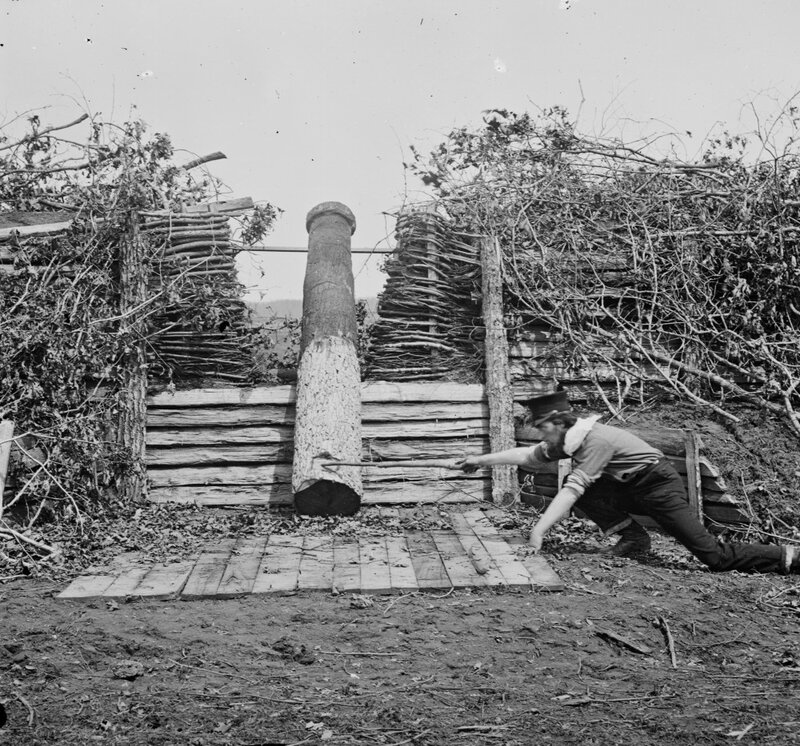 Man operating a large wooden press
