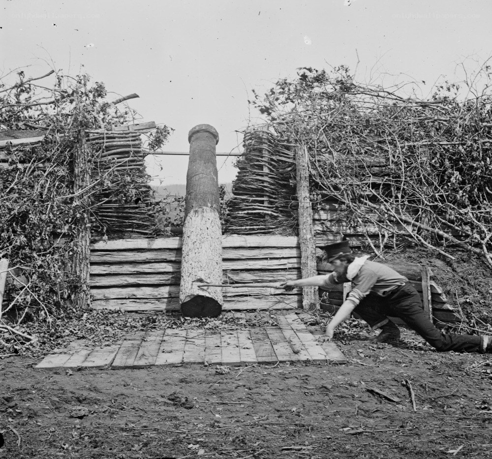 Man operating a large wooden press