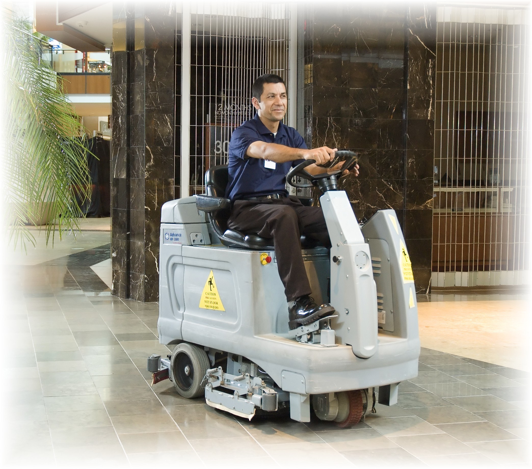 Man operating floor cleaning machine