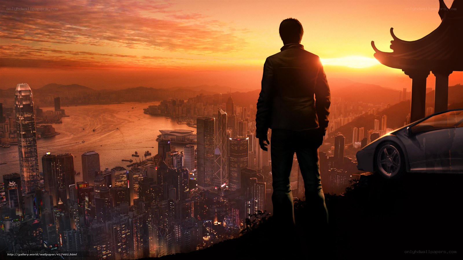 Man overlooking city at sunset