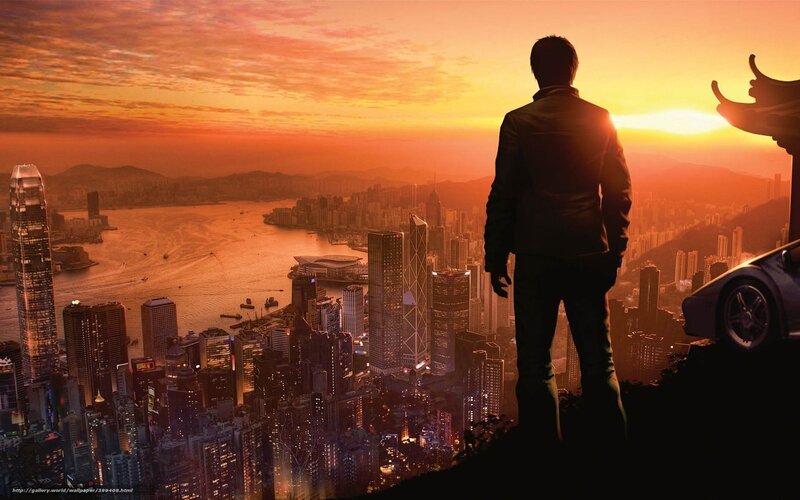 Man overlooking city at sunset